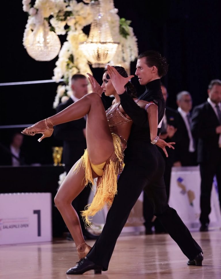 Latin dancers in a dance position at a competition